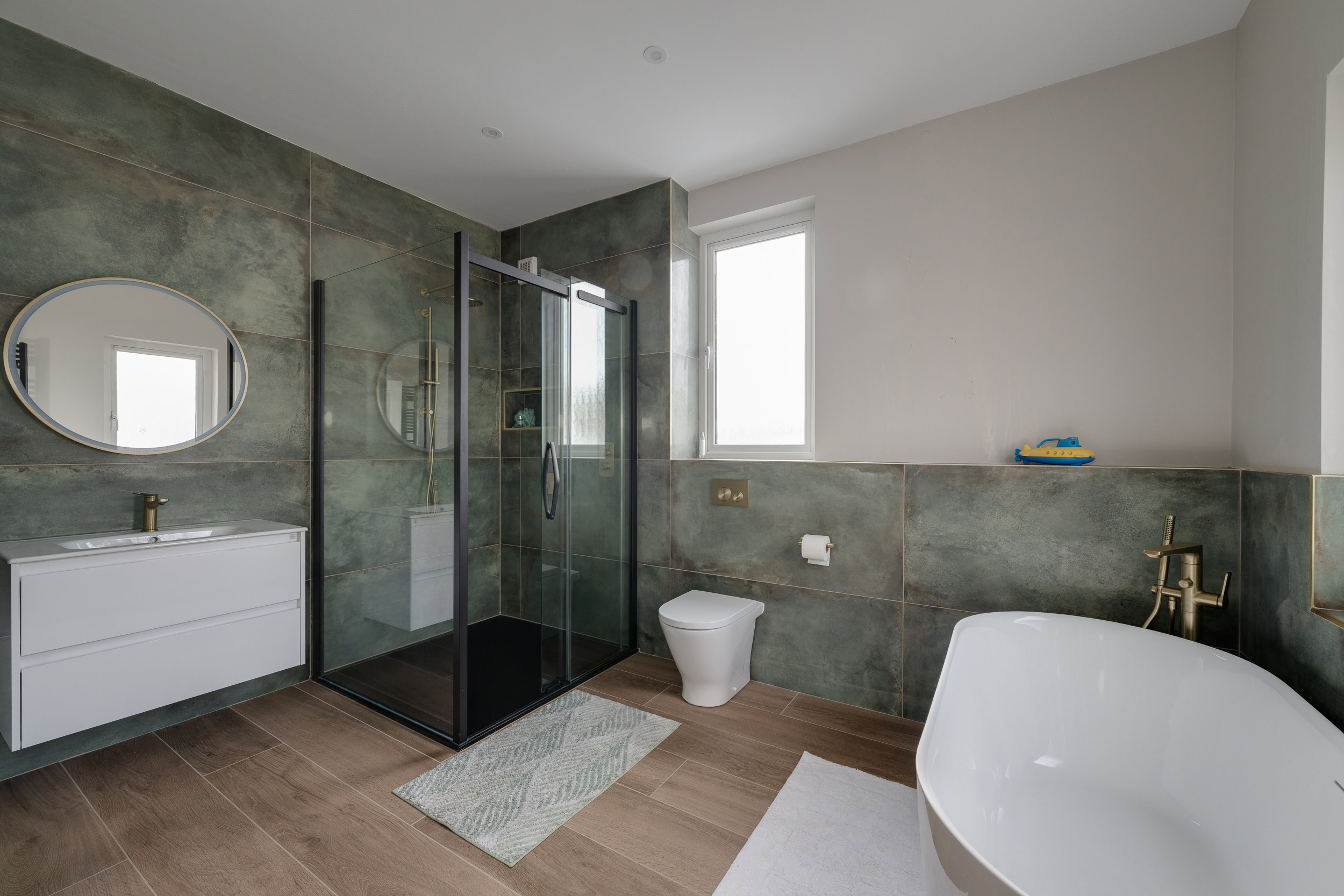 Dark green bathroom with industrial-style fittings