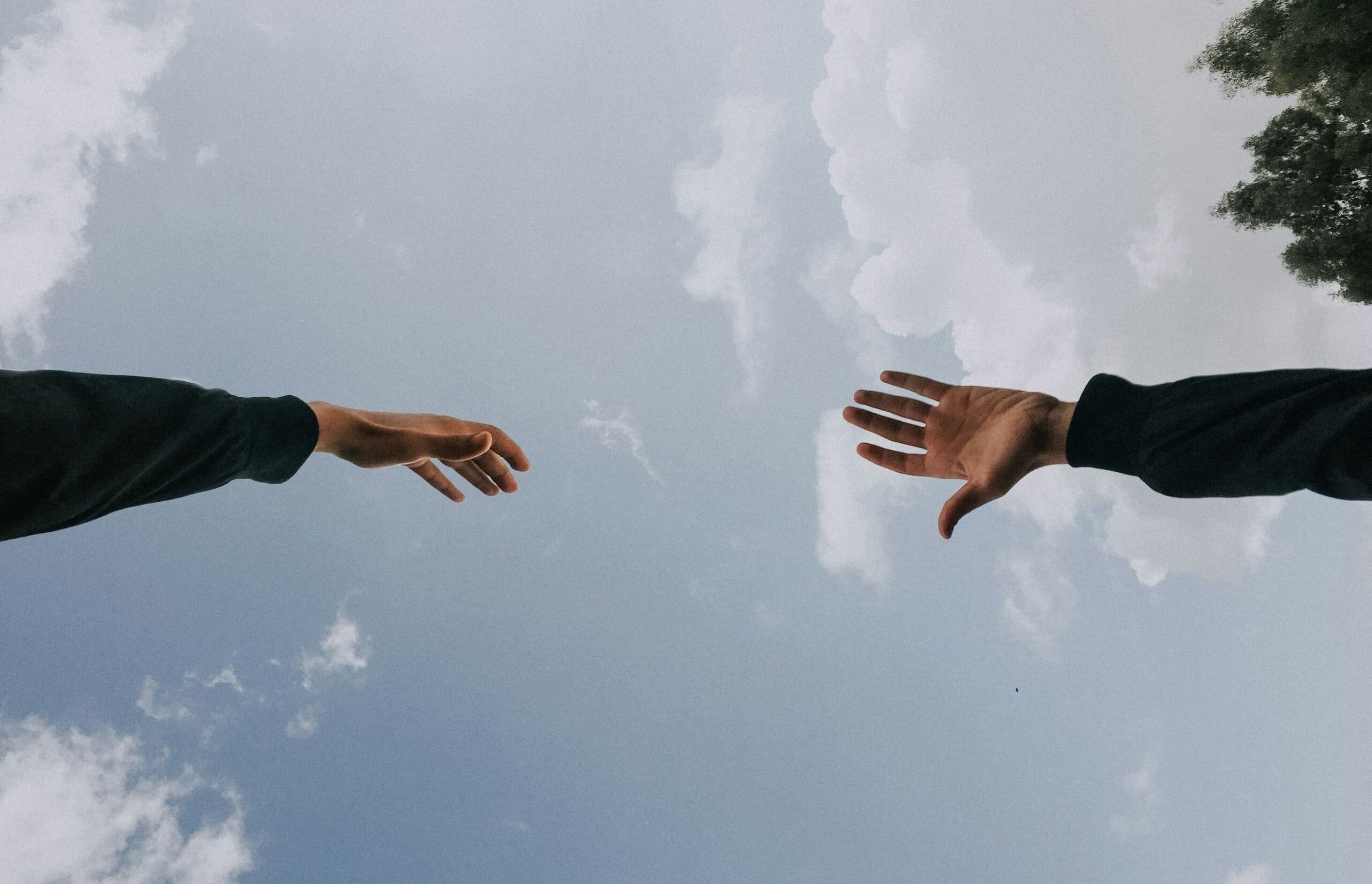helping hands reaching into the sky