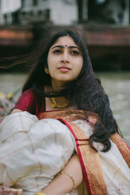 bengali girl in a traditional dress sitting on a boat