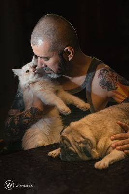 Pet owner cuddles his persian cat
