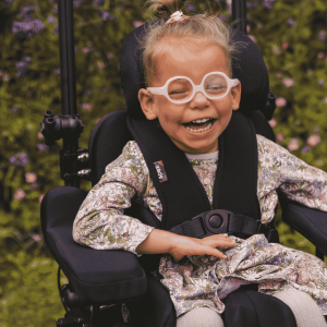 Lifestyle image of a wheelchair user using a pair of height adjustable multiplane arm supports