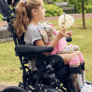 Side-on lifestyle image of a wheelchair user using height adjustable multiplane arm supports (pair)