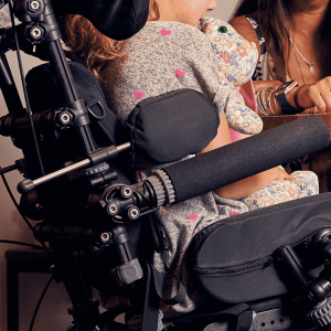 Lifestyle image of a wheelchair user fitted with lateral trunk supports providing side body support