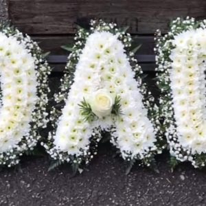 Dad funeral wreath made of white chrysanthemums, white roses, baby’s breath, and greenery – flower tribute in Nairobi.