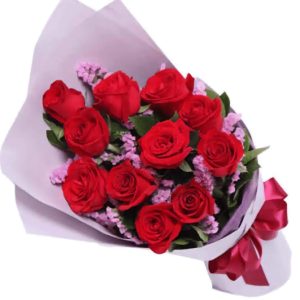 One dozen red roses bouquet with purple fillers, wrapped in elegant floral paper, perfect for Valentine's Day, anniversaries, and romantic flower delivery in Nairobi.