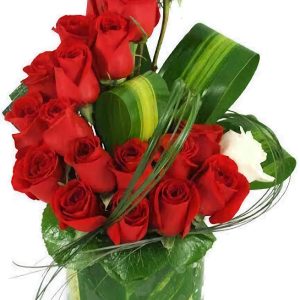 Star of Christmas floral arrangement with 24 red roses and lush greenery in a clear glass vase, perfect for holiday gifting and same-day flower delivery in Nairobi.