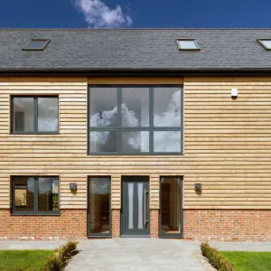 Smarts black Alitherm aluminium windows installed on modern timber-clad house