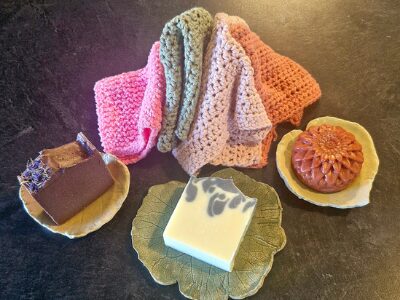 Thoughtful Extras handmade by Fatglow NZ, with pottery soap dishes showcasing tallow soaps and knitted face cloths