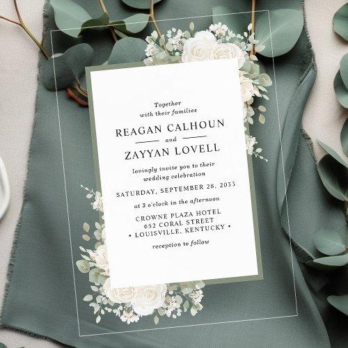 Elegant Acrylic Wedding Invitation Featuring An Ivory &Amp; Sage Floral Frame, Placed On A Deep Green Fabric With Eucalyptus Leaves, Perfect For A Romantic Wedding.