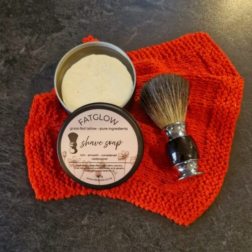 Grass-fed tallow cedarwood shave soap in tin, rich smooth shave, on black slate with badger shave brush - Fatglow
