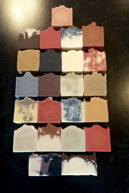 Grid of grass-fed tallow soap NZ in a range of botanical colours and swirls, handmade by Fatglow in Taranaki, New Zealand