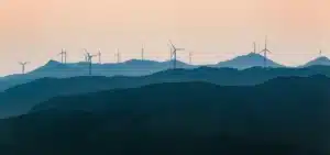 Wind farm with multiple turbines on hilly terrain, representing a renewable project.