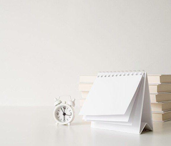 Calendar with bunch of books and clock