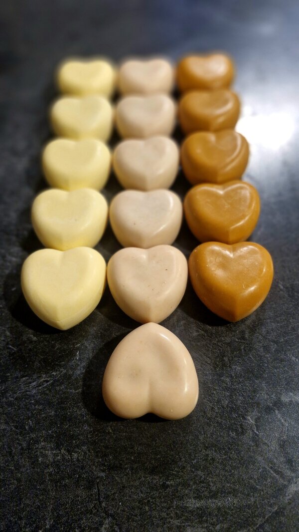 Heart-shaped grass-fed tallow soap in yellow, cream and amber botanical shades, handmade by Fatglow