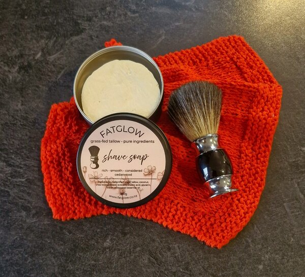 Grass-fed tallow cedarwood shave soap in tin, rich smooth shave, on black slate with badger shave brush - Fatglow