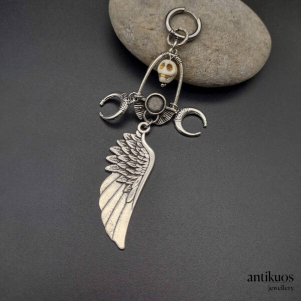 The sorcerer, large earring with a skull, moons and large angel wing, small hoop