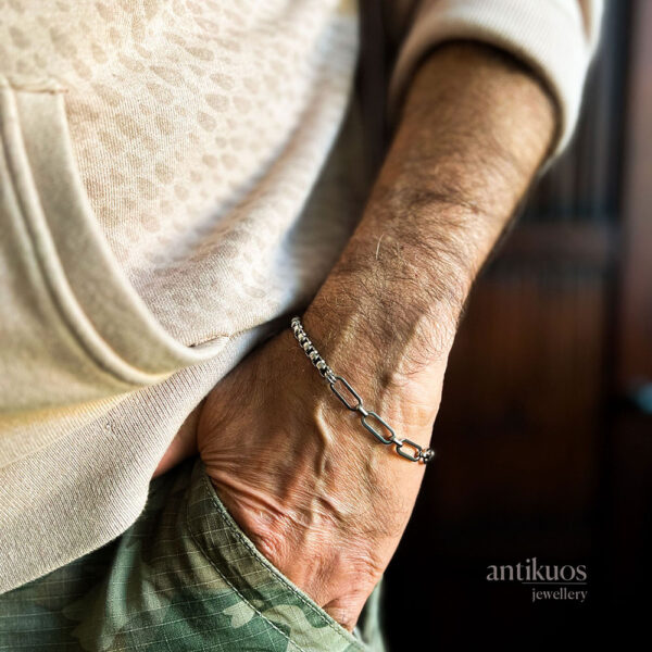 Hand wearing a chain bracelet in pocket