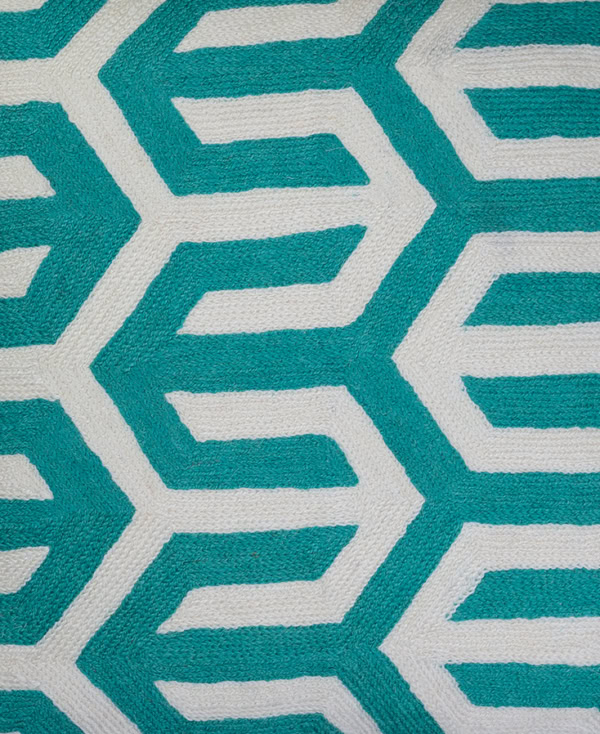 Close-up view of Grey silk cushion cover with interlocking geometric print in vibrant teal from Mulberry Home India