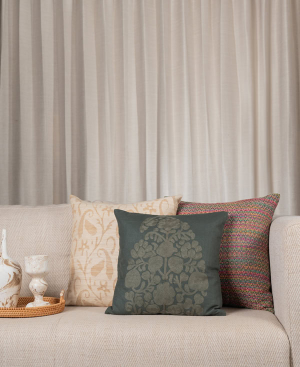 Couch with teal themed designer cushions from Mulberry Home India