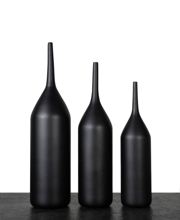 Three black ceramic decorative vases of different heights in a line from Mulberry Home India
