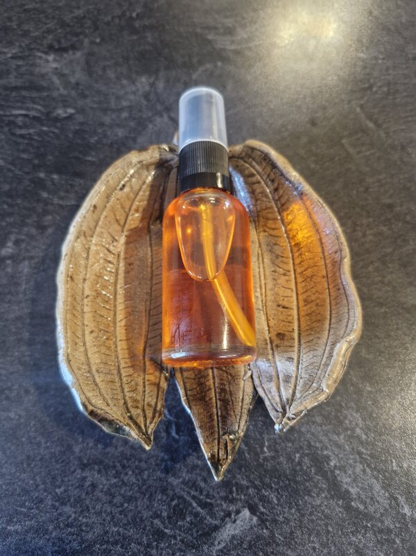 Botanical glow serum in a soap dish, formulated with grass-fed tallow and cold pressed botanicals