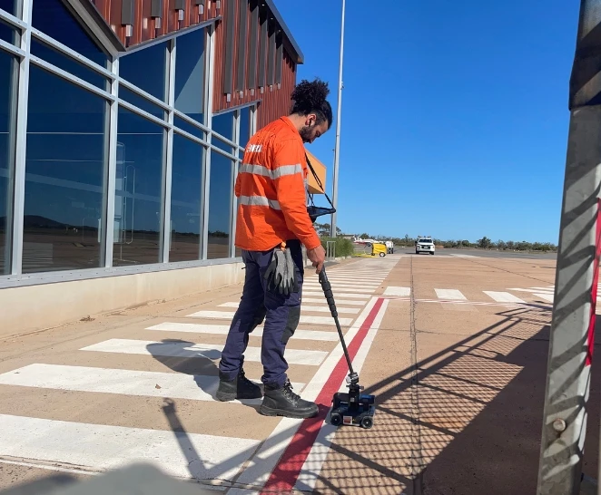 Technician analyses airport concrete slab - SureScan structural integrity services - Brisbane & Adelaide