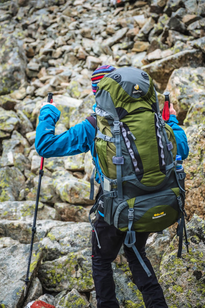 Wanderer mit Stöcken und Rucksack