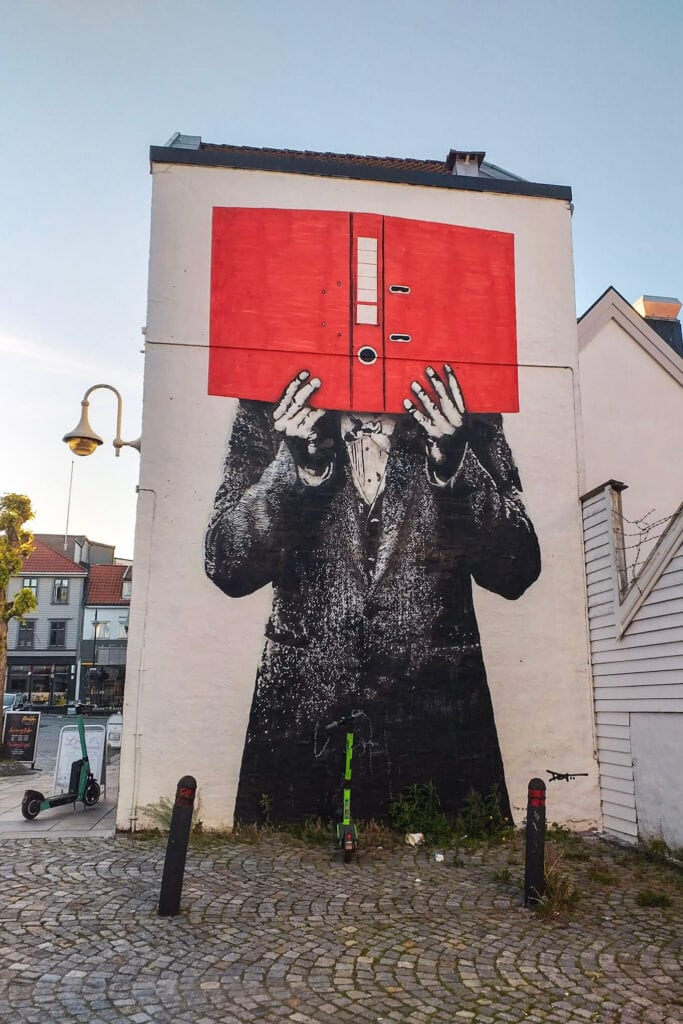 Street art in Stavanger city centre - a man hiding his face behind a book