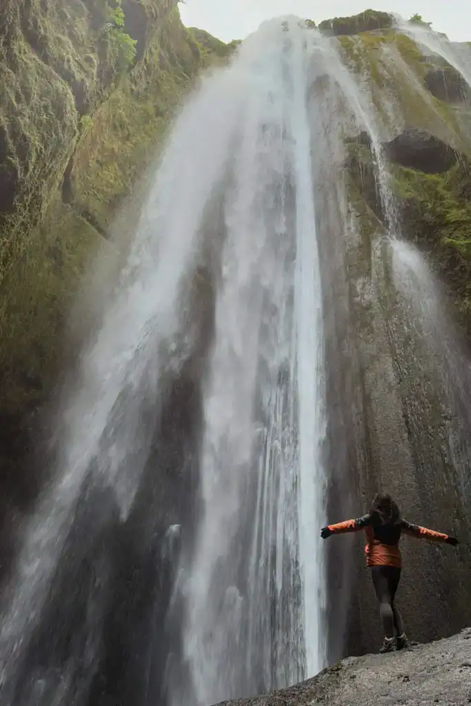 Alice standing on the rock in the canyon at Gljúfrabúi Waterfall