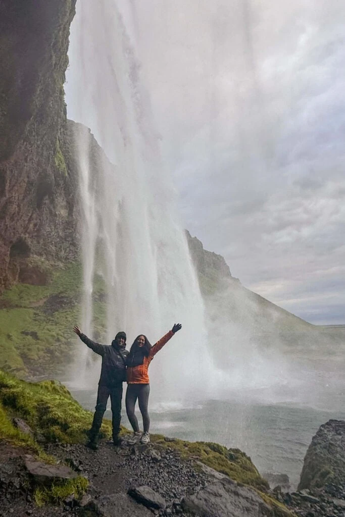 Andrew and I walking behind Seljalandsfoss waterfalls