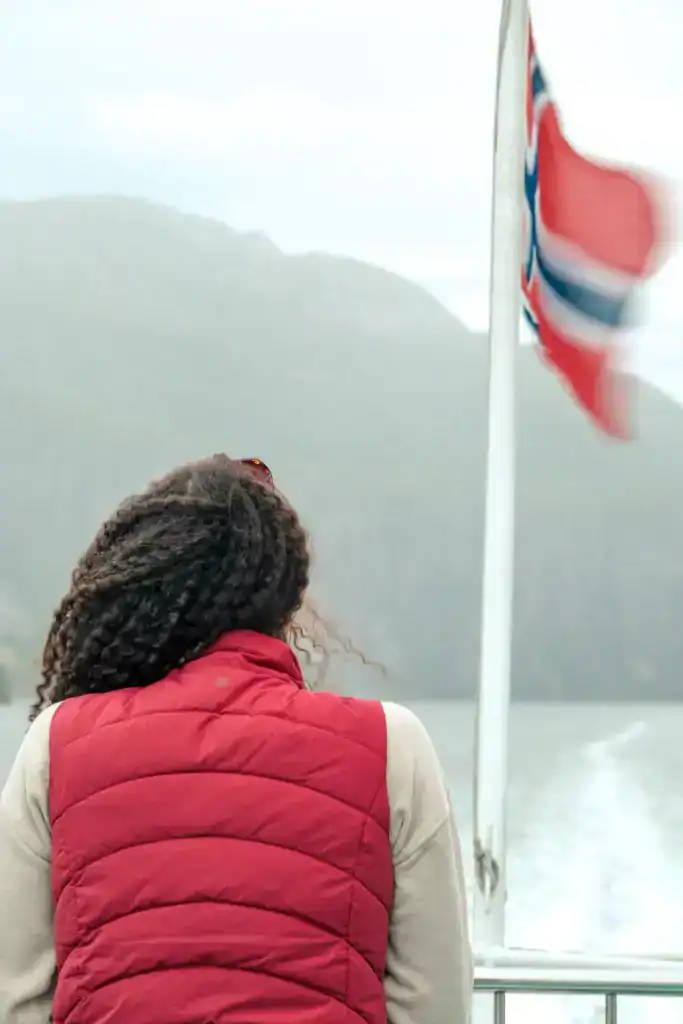 Alice on a fjord cruise with the Norway flag