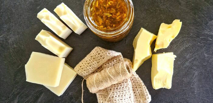Grass-fed tallow, rendered blocks, and calendula-infused oil, the raw ingredients behind Fatglow soap