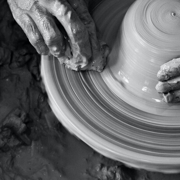 Smooth pottery wheel representing flawless, porcelain-like skin achieved through dermatology treatments
