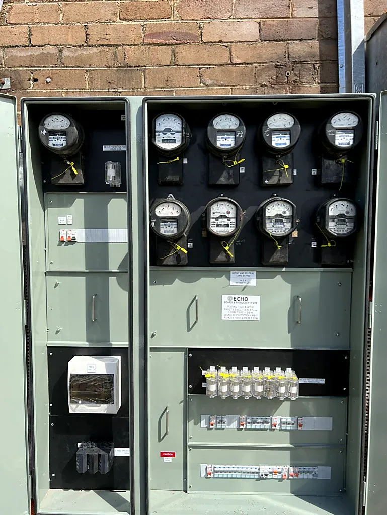 Old analogue multi-tenancy strata meter bank awaiting switchboard upgrade by SRS Services in Manly