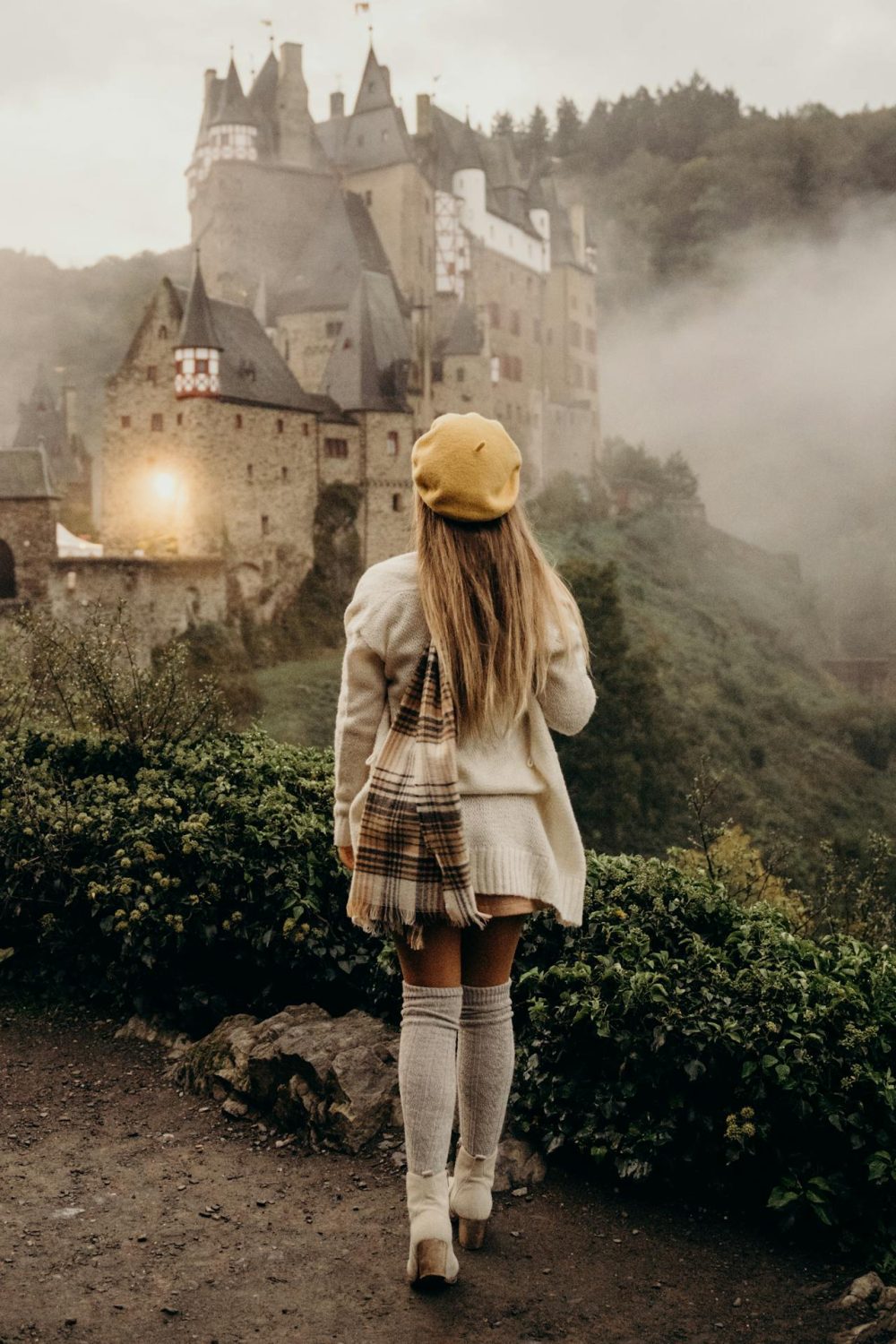 Woman standing near a castle, fairytale experience 
