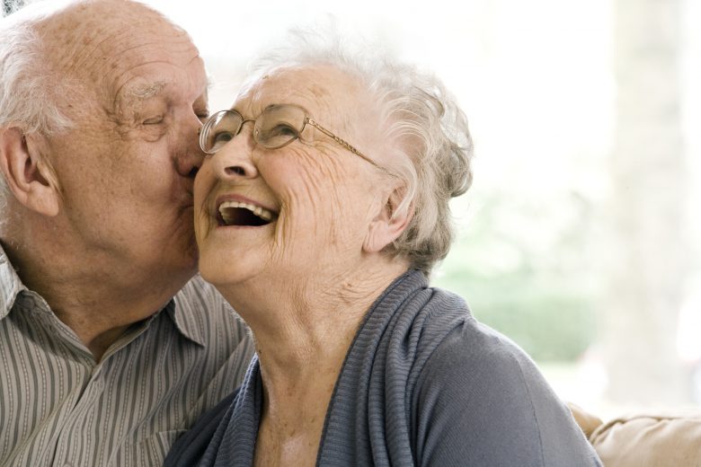 Elderly Man and Woman on Couch in Nursing Home