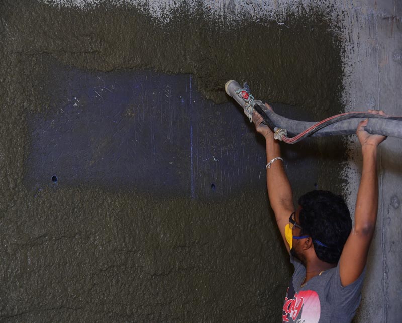 Spray application of Ideal Drymix plaster on wall surface