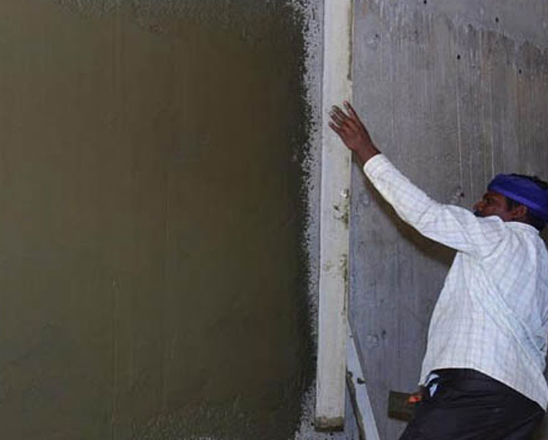 Applying Ideal Drymix plaster on wall surface for smooth finish