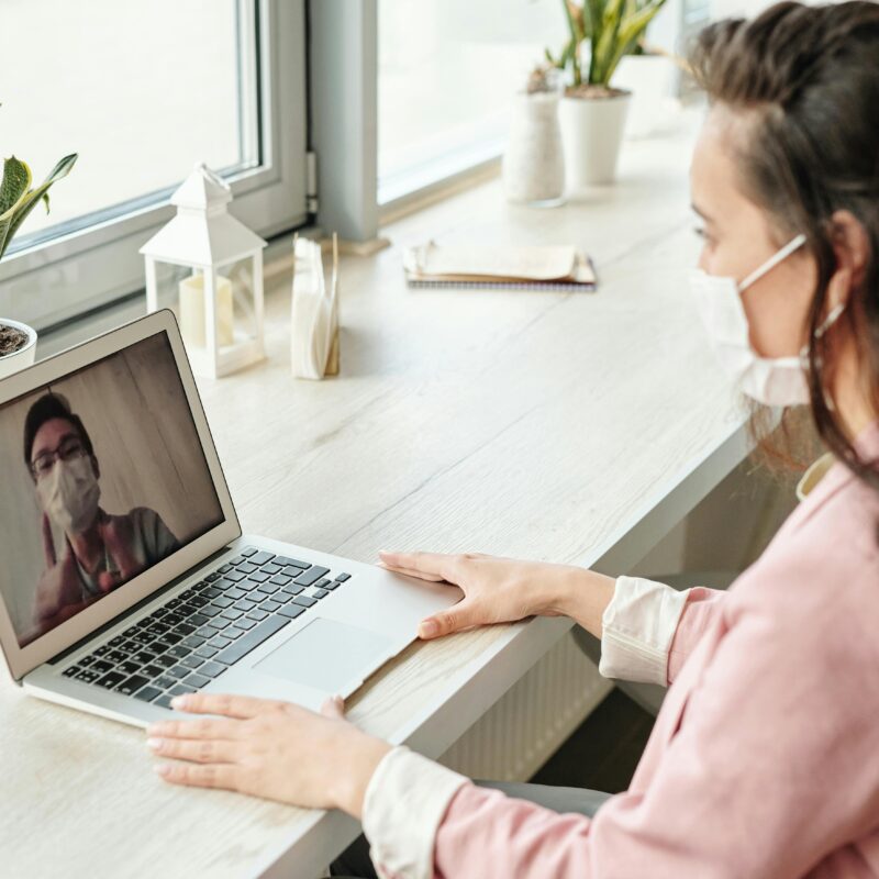 Woman on a video call with a healthcare professional.