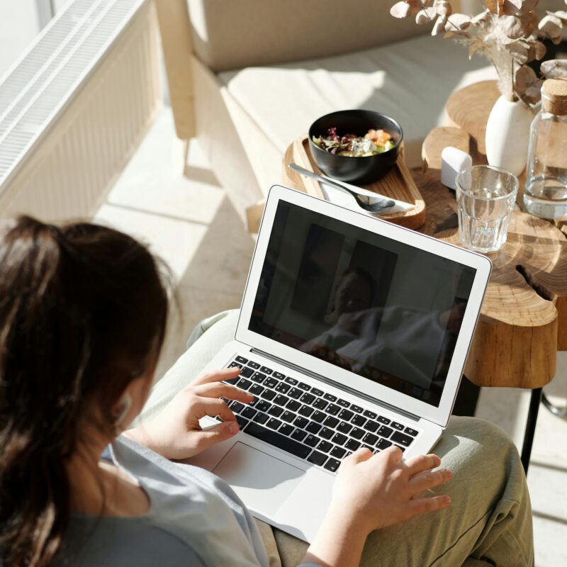 A woman working from home on a laptop.