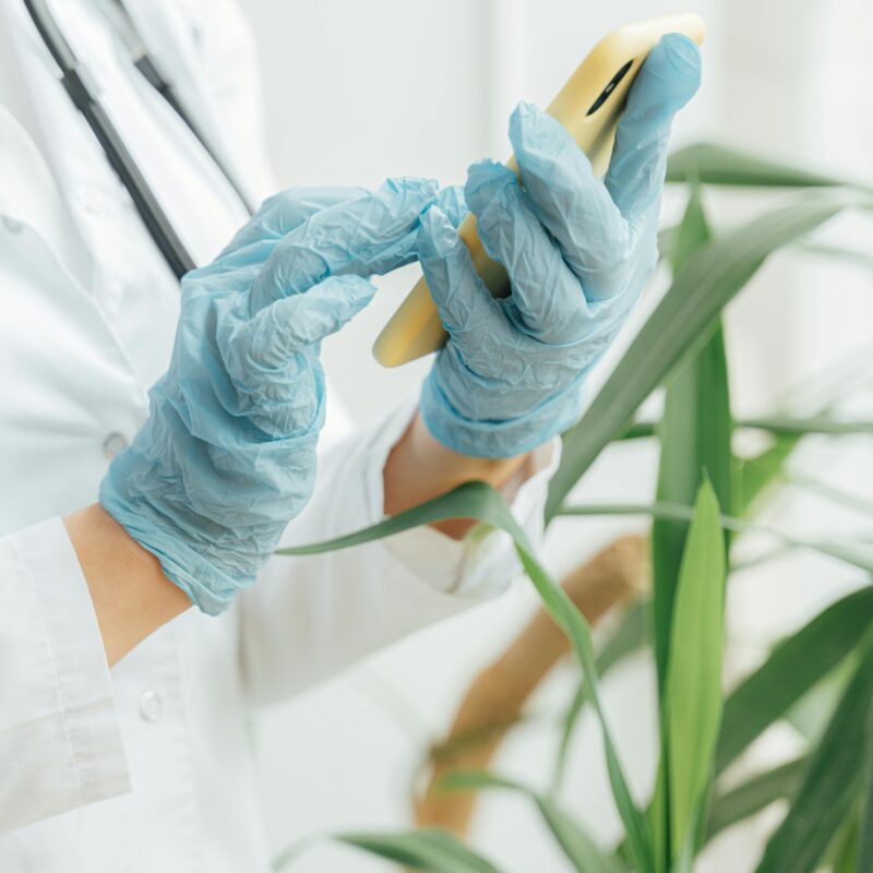 pharmaceutical social media photo featuring a healthcare worker looking at their phone