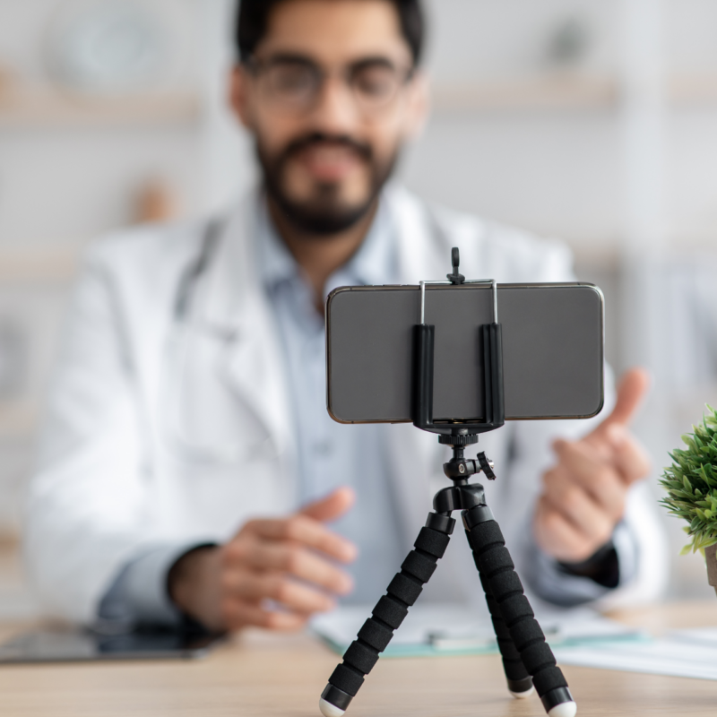 healthcare influencer creating a video on his phone.