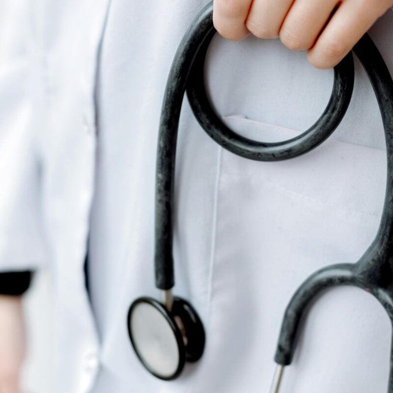 How Healthcare Brands Can Reach Patients in a Digital-First World article banner featuring close up shot of doctor holding stethoscope