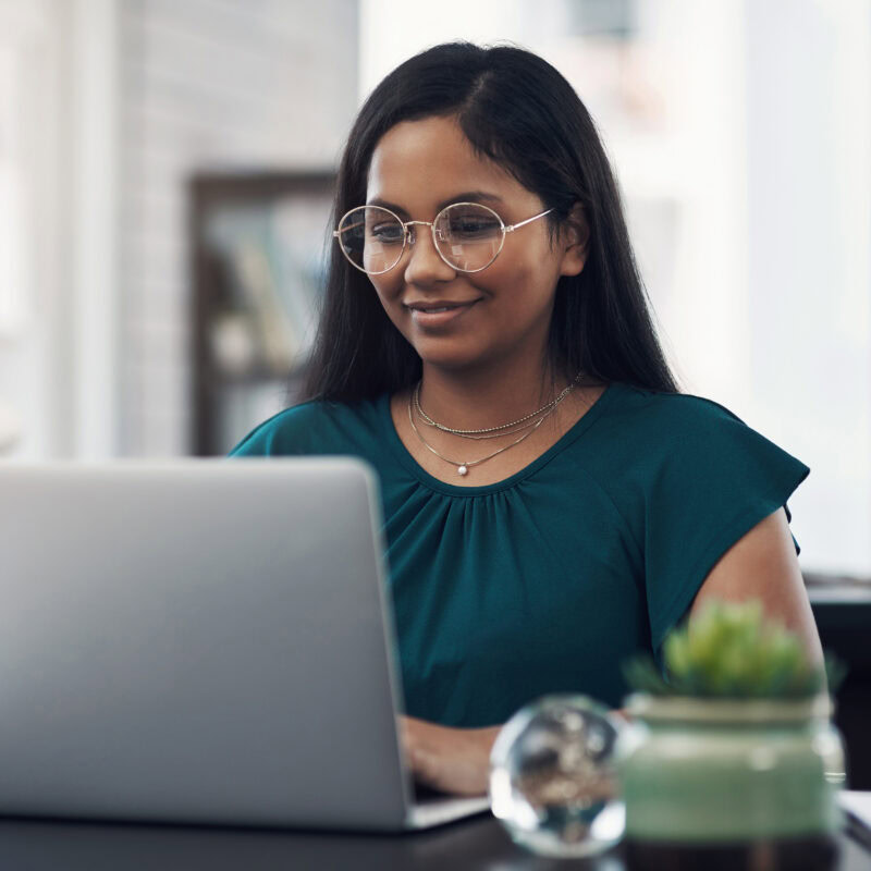 AEO for Healthcare Brands: Mastering AI Search article banner featuring woman using laptop