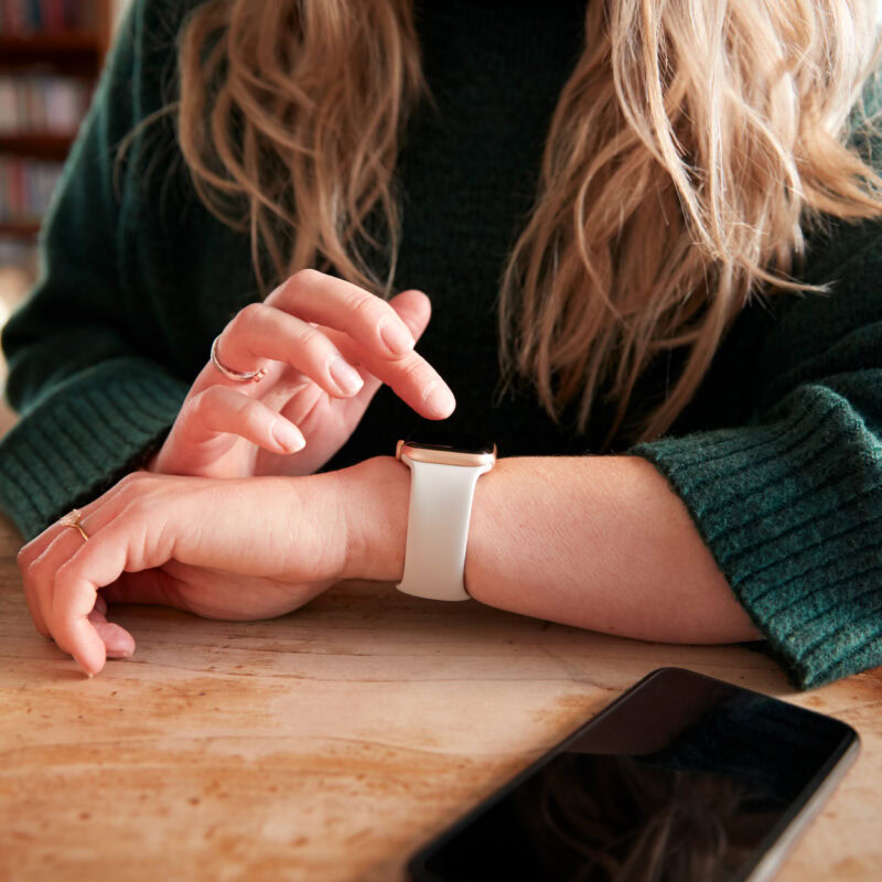 Precision Pharma AEO Strategy for Niche Patient Discovery article banner featuring a woman looking at her smartwatch