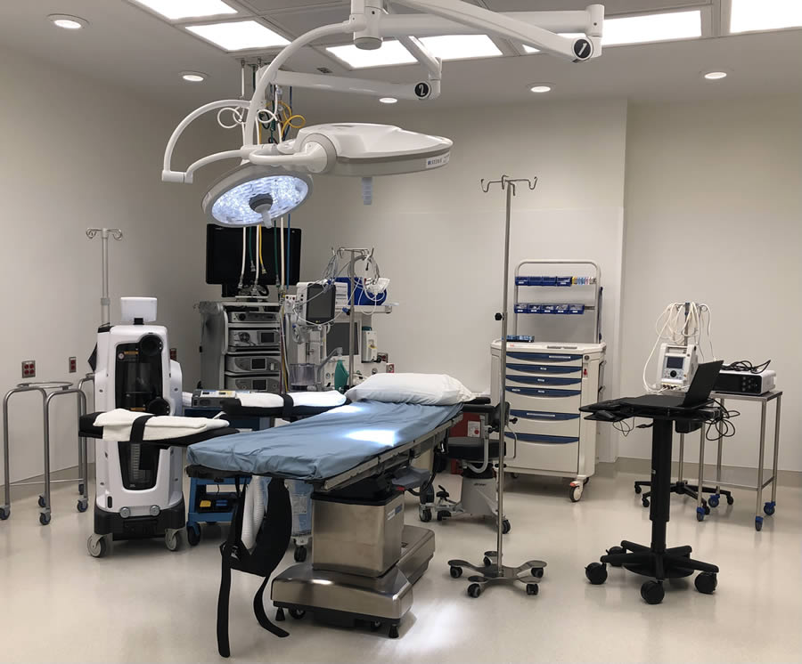 Surgery Center of North Central Ohio operating room prepared for surgery. Sterile surgical operating room with medical equipment and surgical lights.