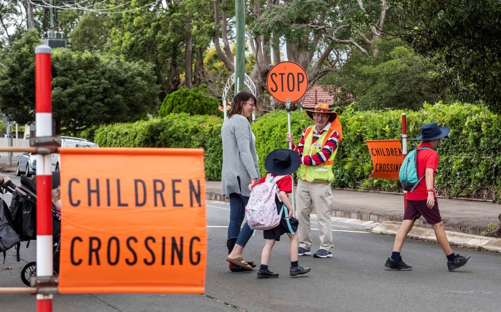 Children safely crossing the road to get to school
