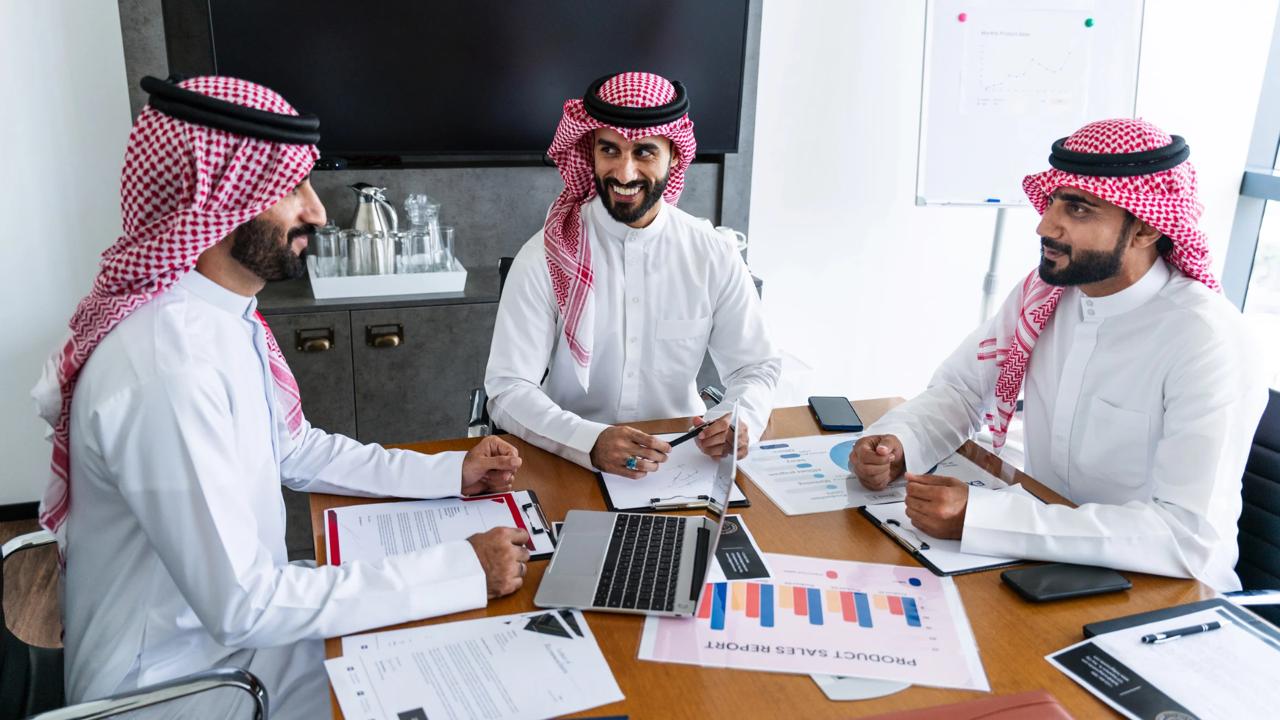 Saudi and international business professionals in corporate meeting
