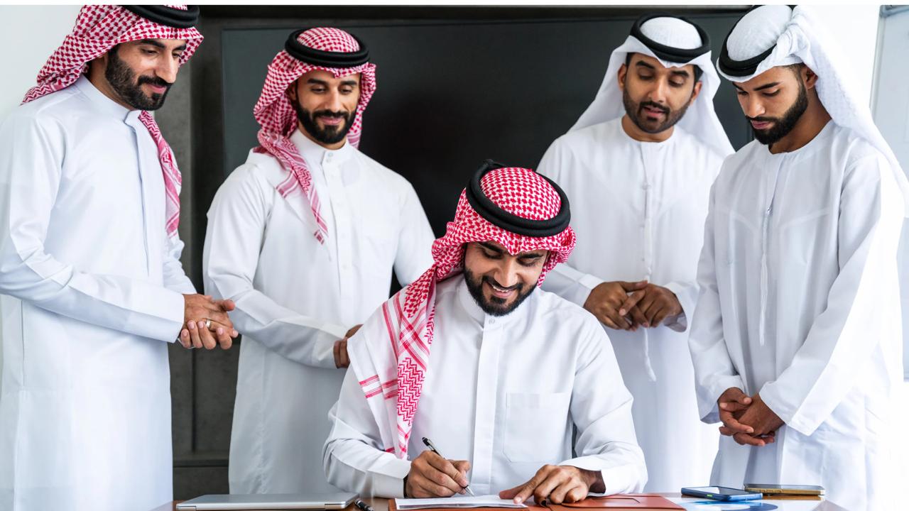 Business consultancy meeting in modern Saudi office