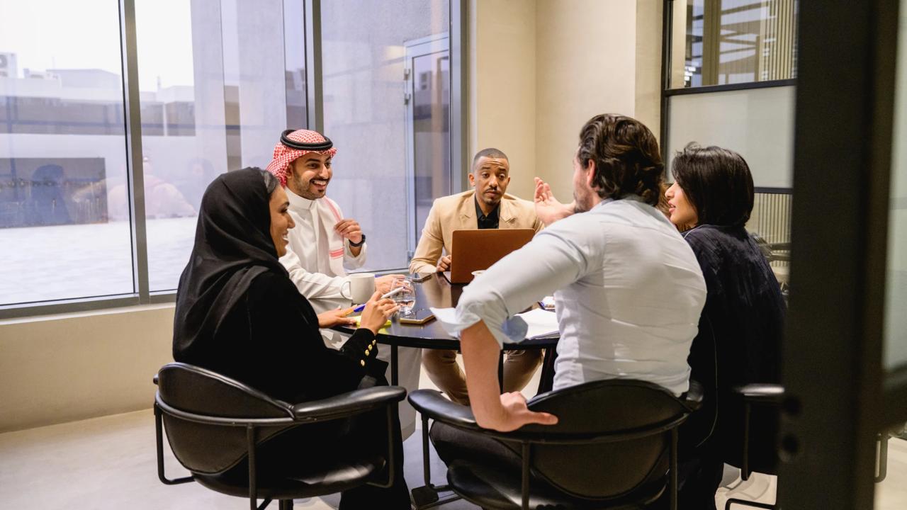 Professional corporate strategy meeting with Saudi business team
